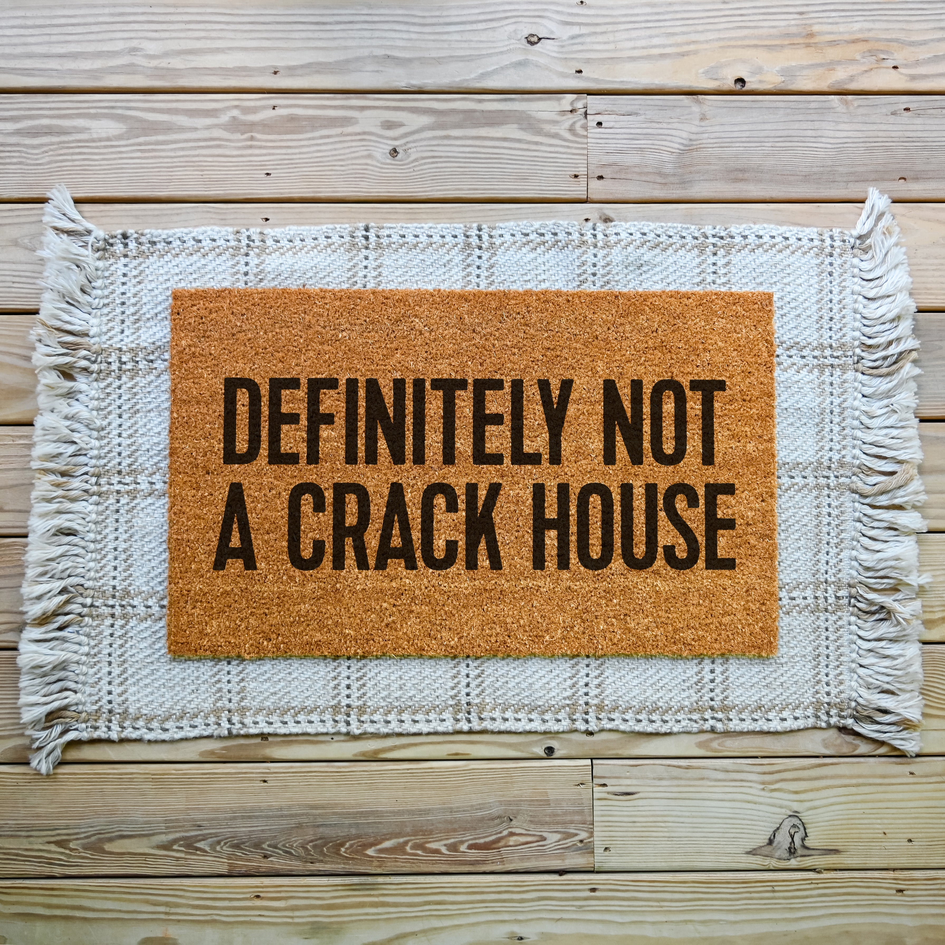 funny doormat that says definitely not a crack house