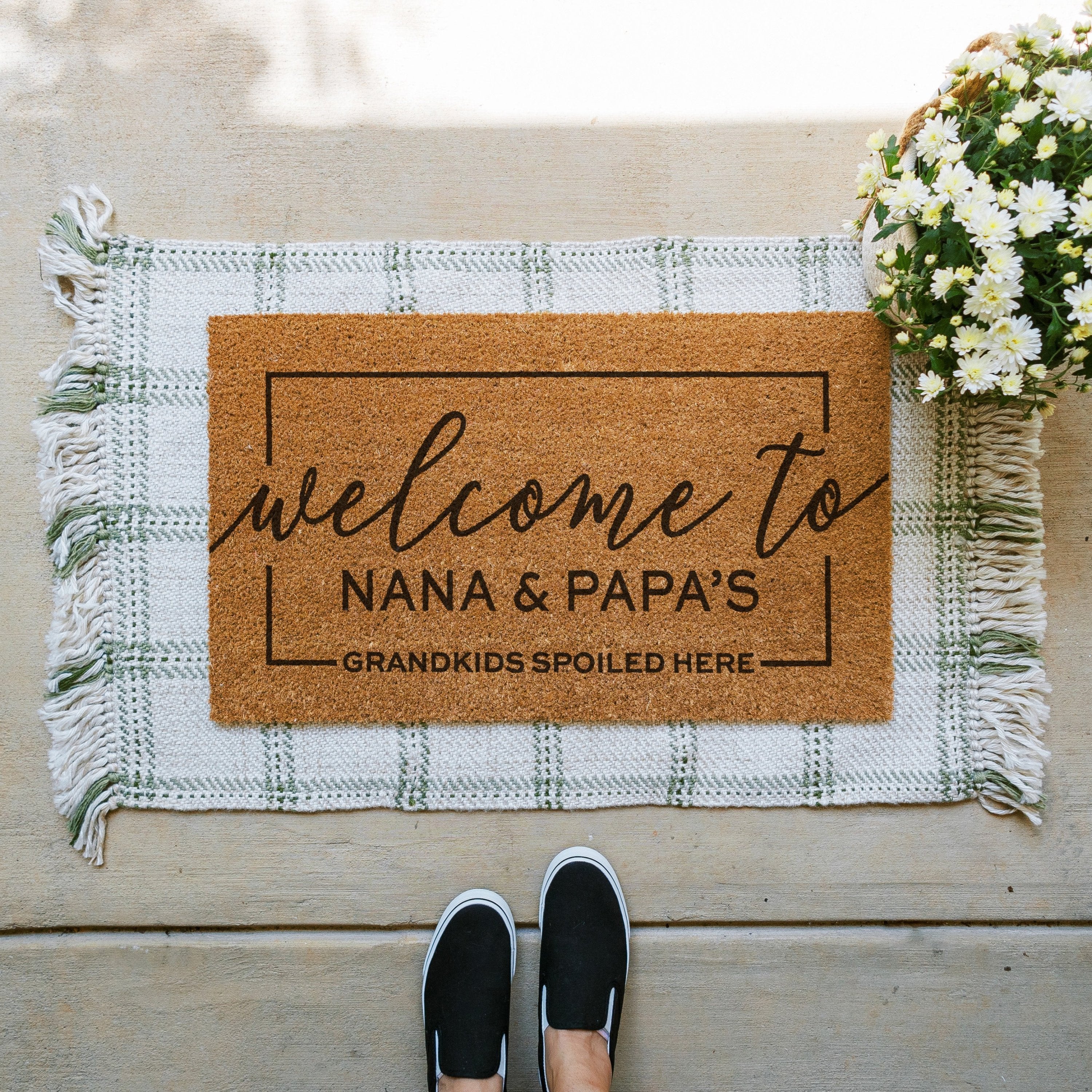 personalized doormat that says welcome to nana and papa's house. Grandkids spoiled here. The names are customizable.