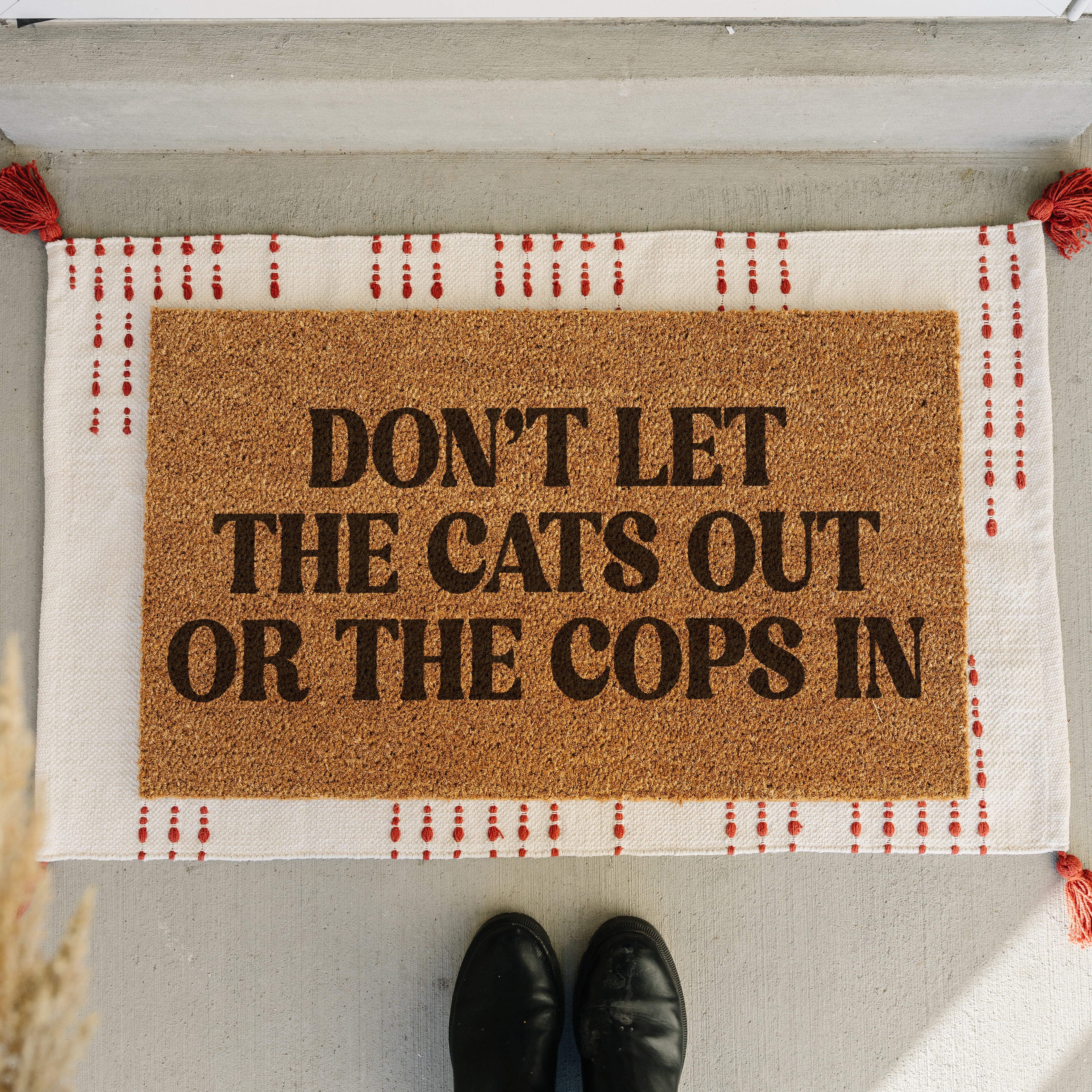 personalizable dunny doormat that says don't let the cats out of the cops in