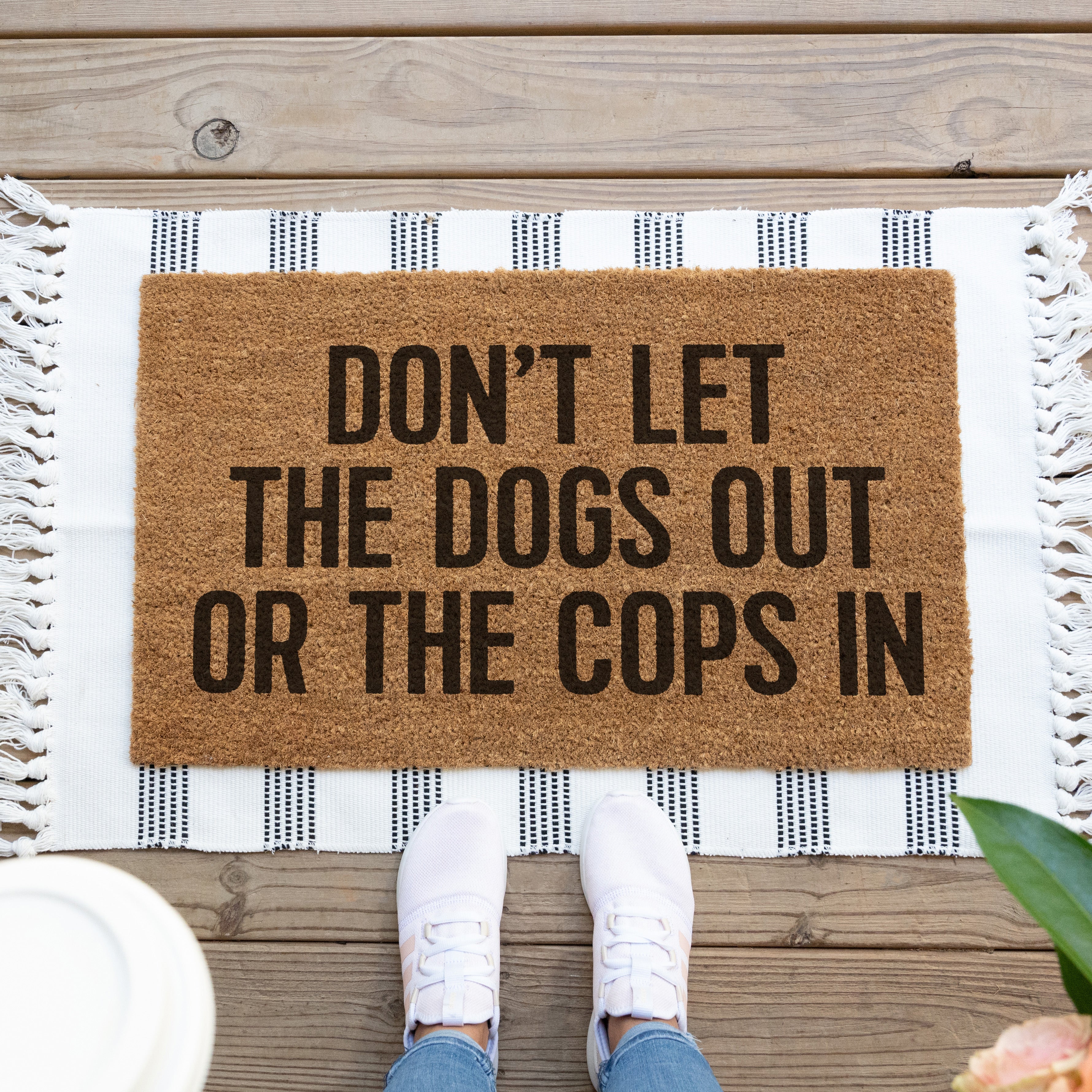 funny personalizable doormat that says don't let the dogs out or the cops in
