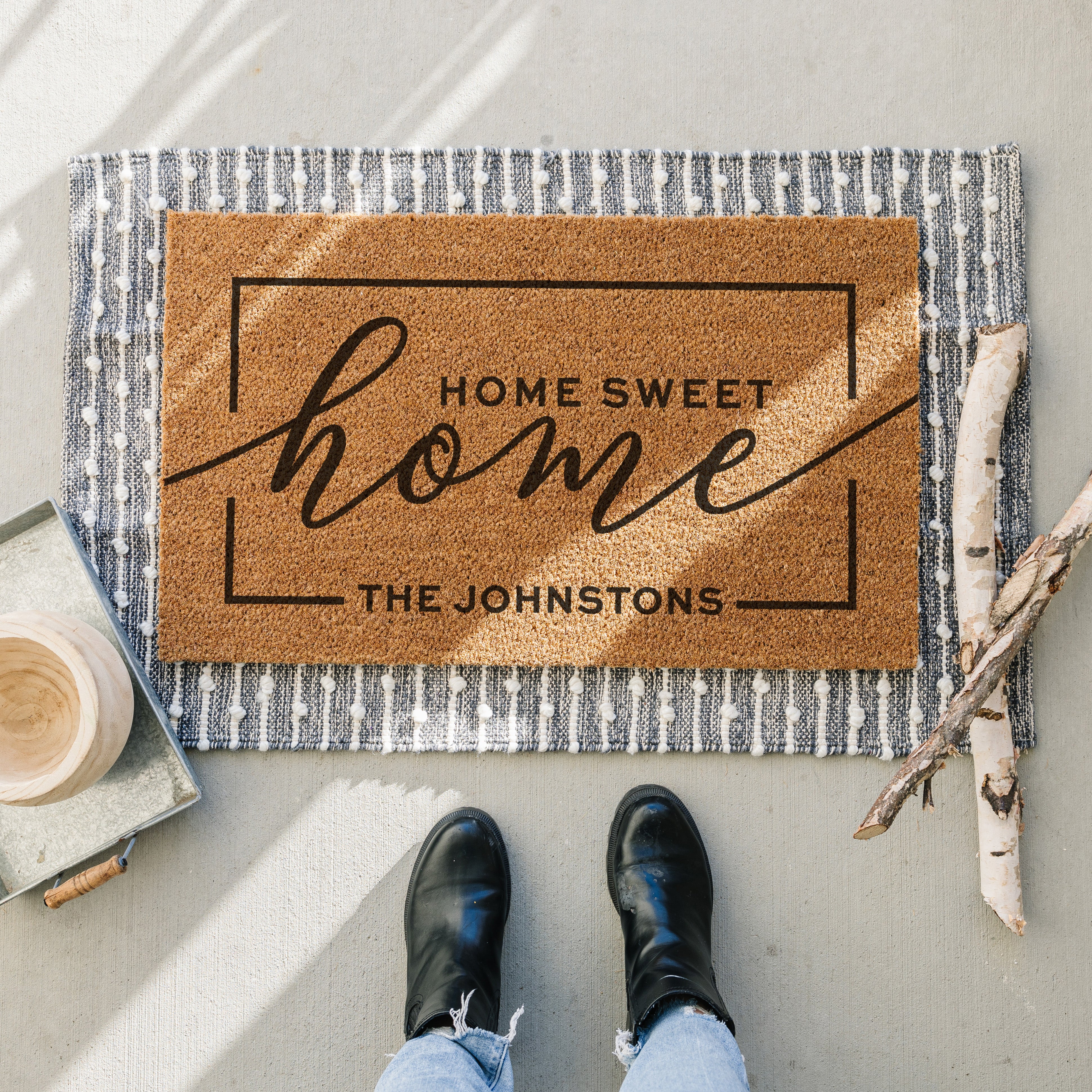 personalized doormat that says home sweet home. At the bottom there is a place to put your last name. The Sample reads "The Johnstons"