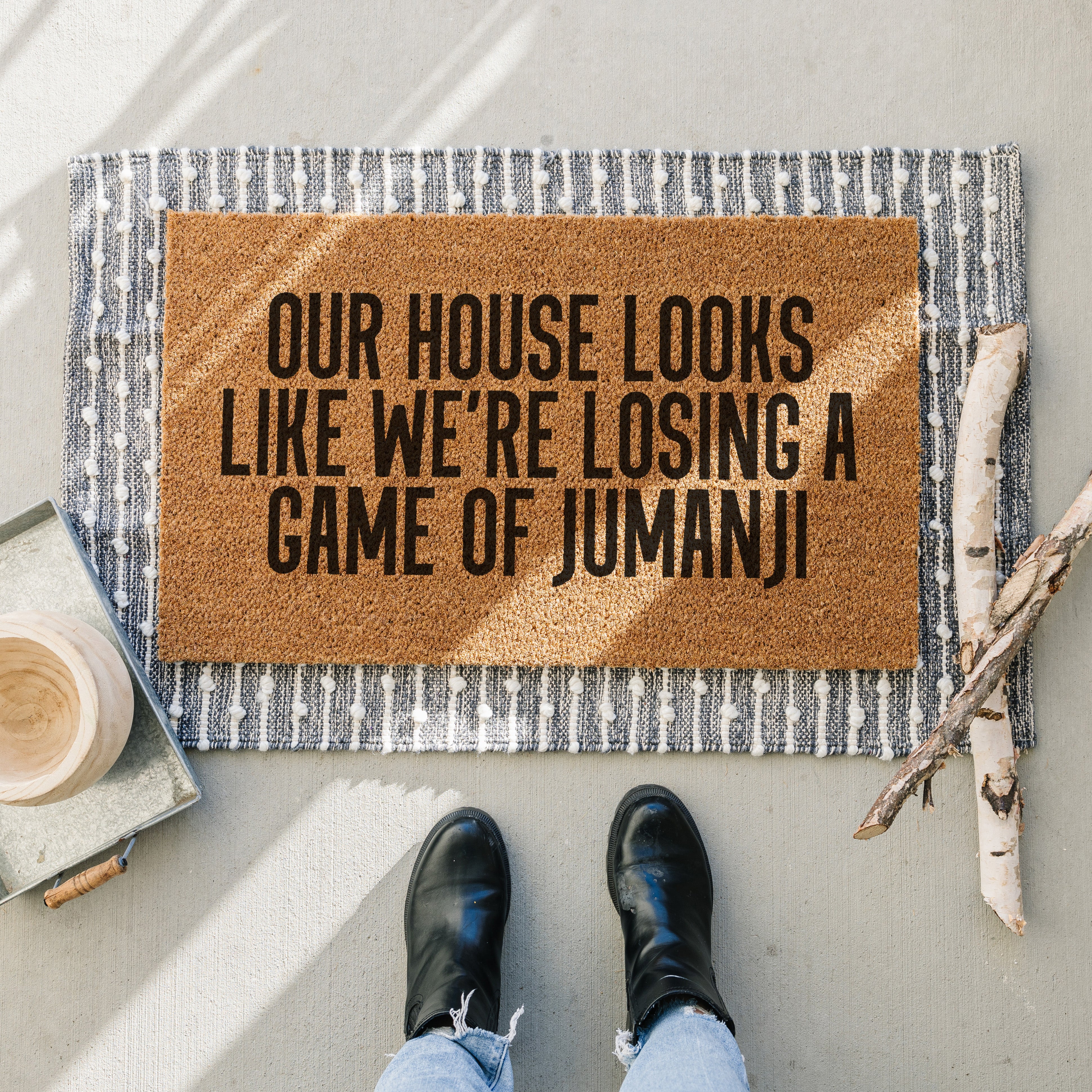Coir doormat. Our house looks like we're losing a game of Jumanji doormat. Three lines of text.