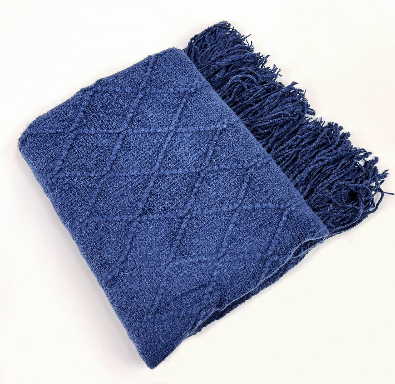 Blue knitted throw blanket with fringes on a white background