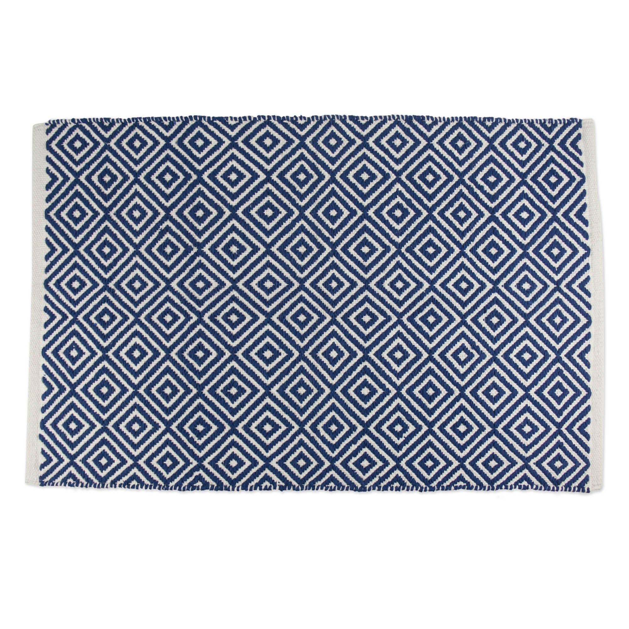 Blue and white geometric patterned rug on a white background