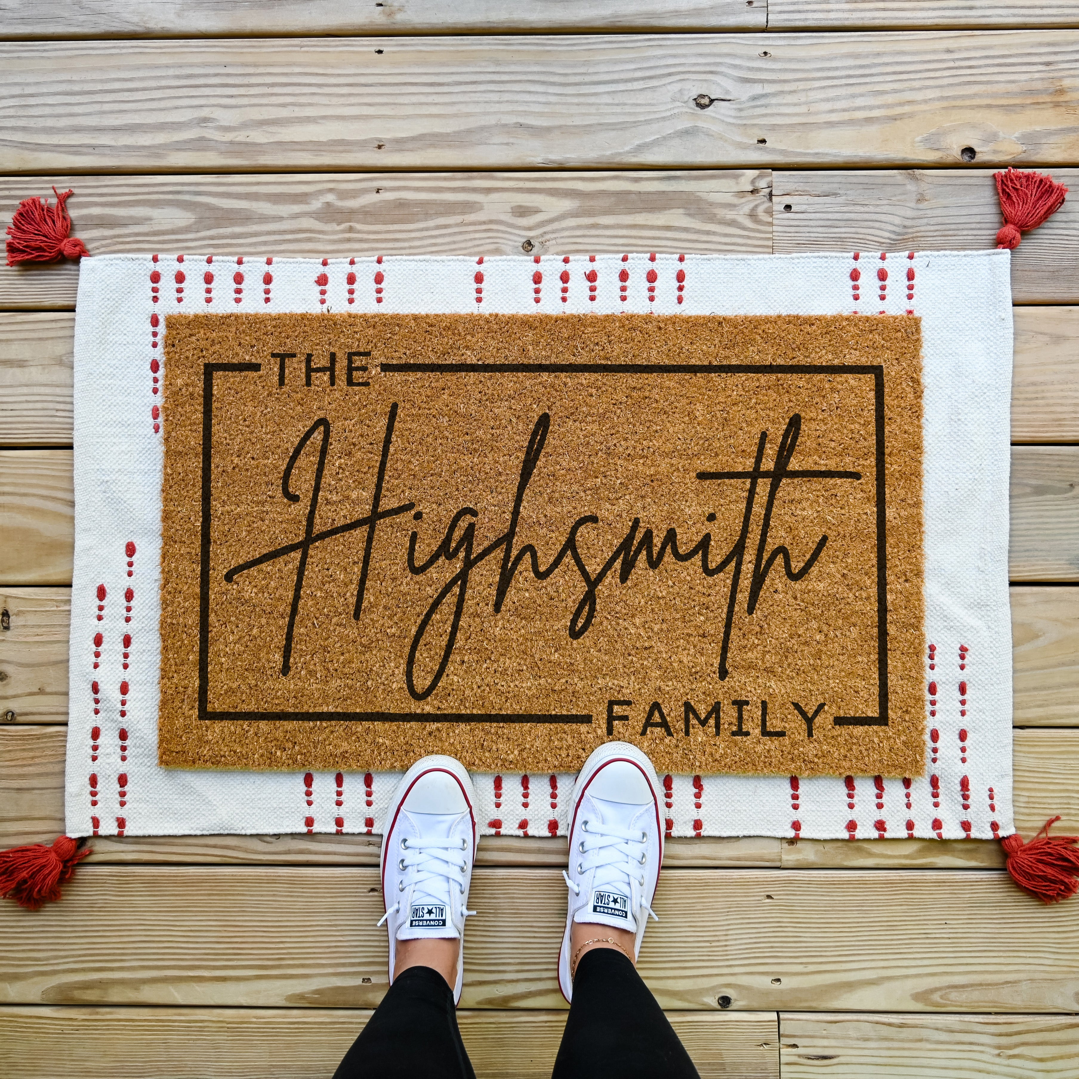 custom doormat with personalized last name in cursive and thin border around the edge