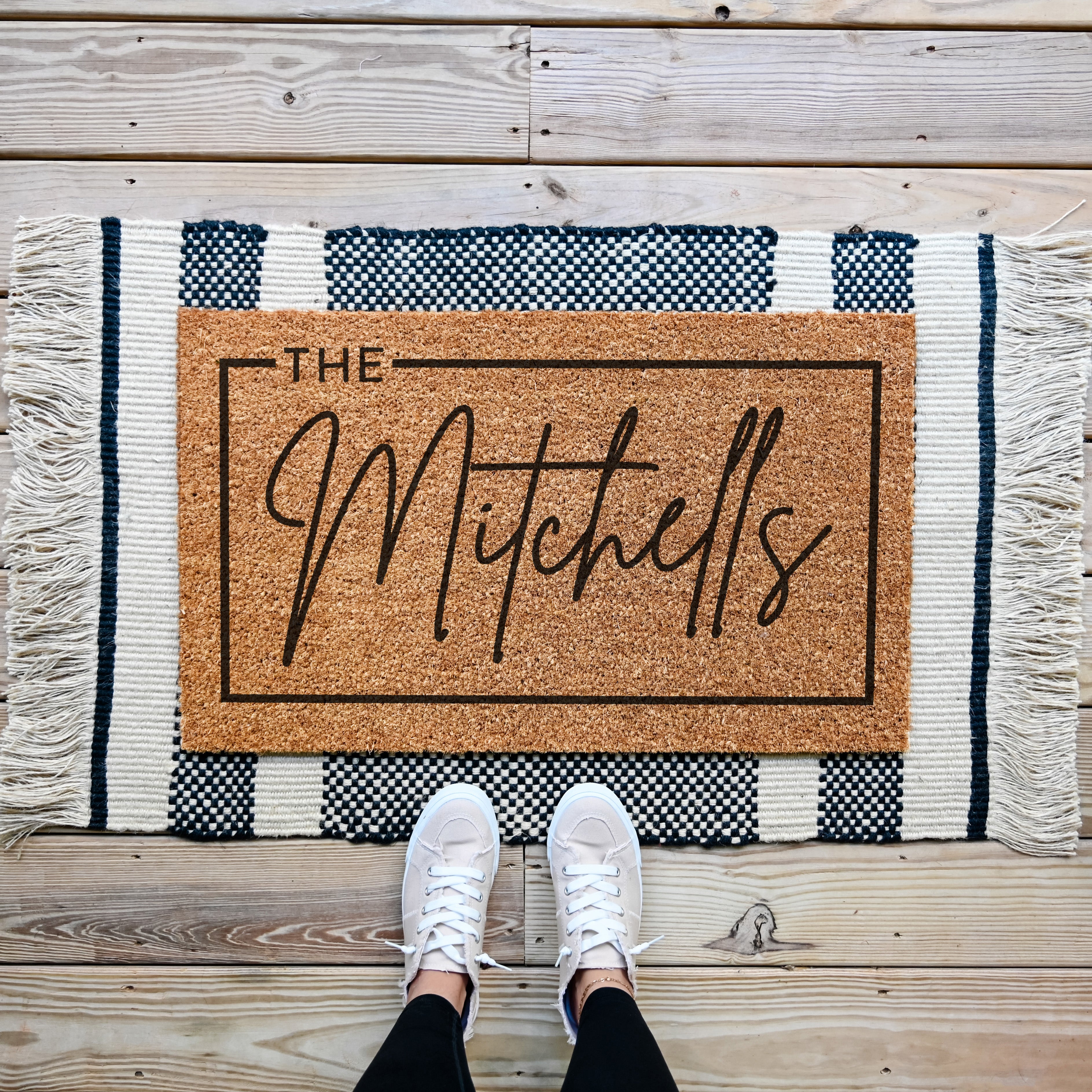 custom doormat with personalized last name. Thin border around the edge.