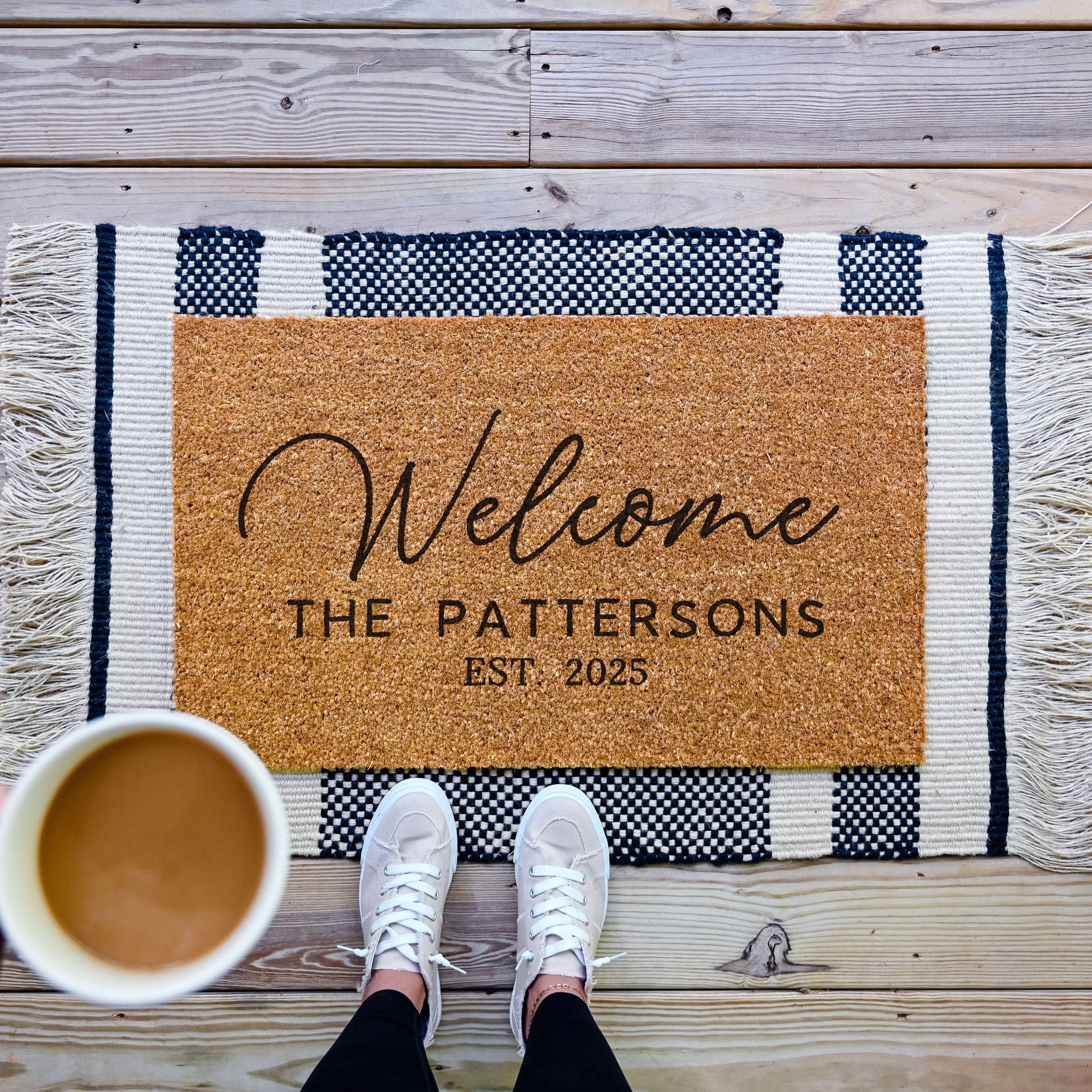 Personalized Doormat that says welcome in an elegant cursive and has a space underneath that reads "The Pattersons"