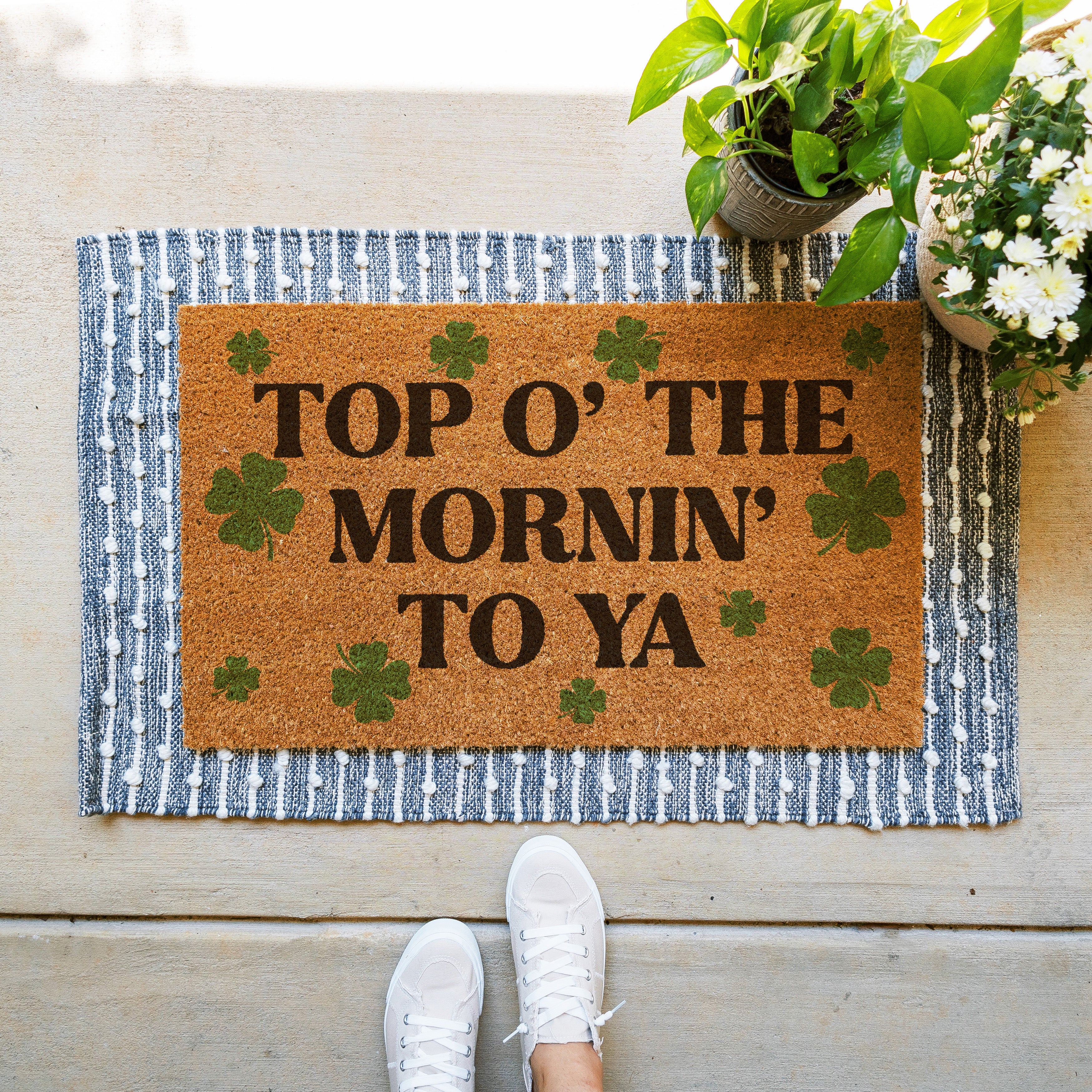 St Patricks Day themed doormat that says Top O the Mornin To Ya with green shamrocks all over it