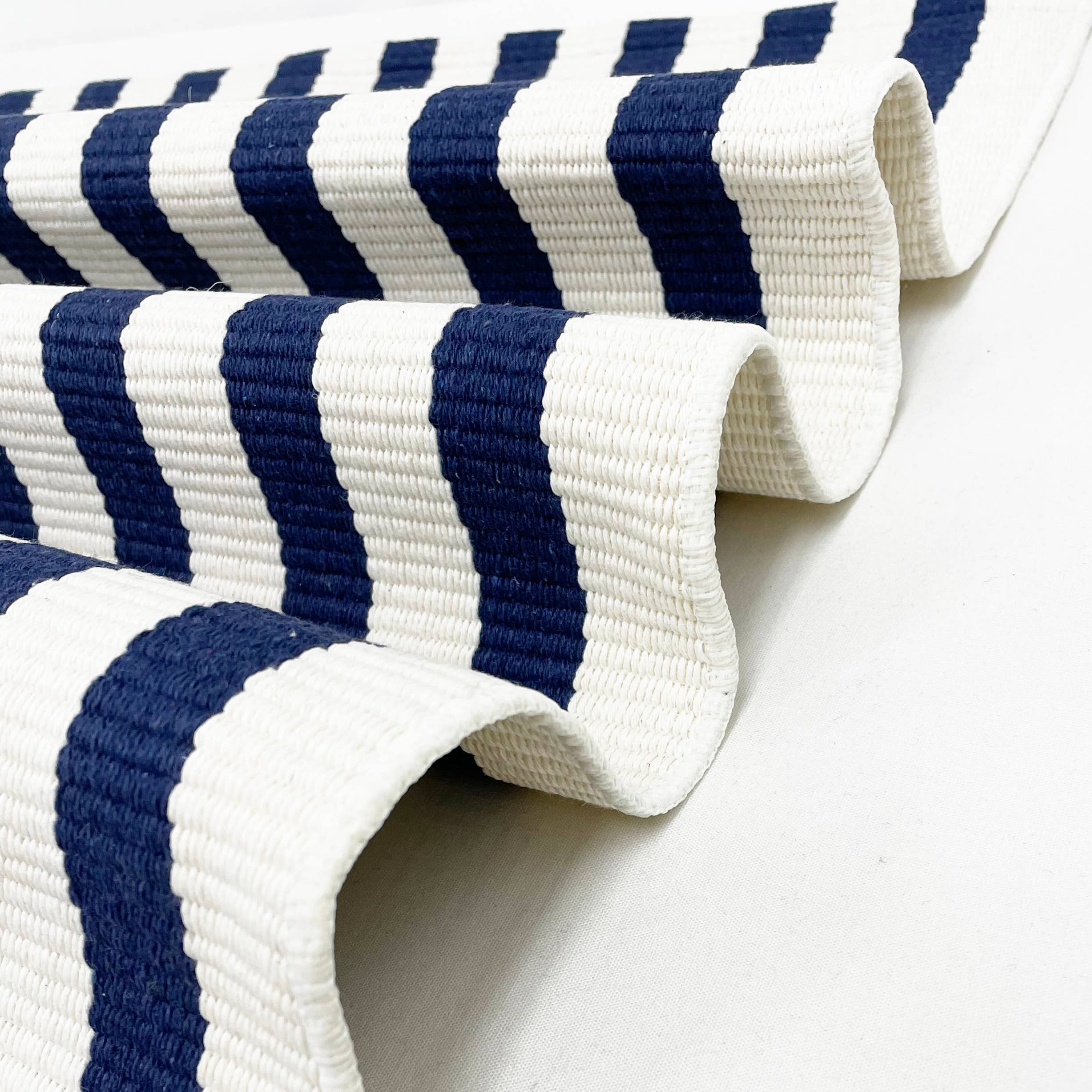 Close-up of a blue and white striped fabric on a white background
